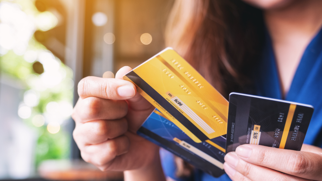 woman holding several credit cards