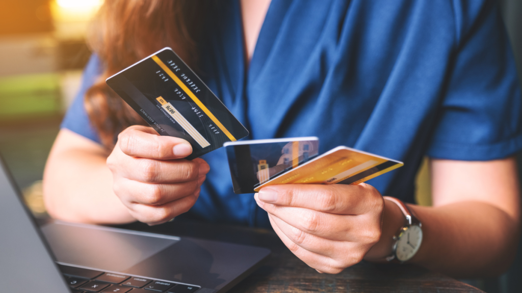 woman holding 3 credit cards